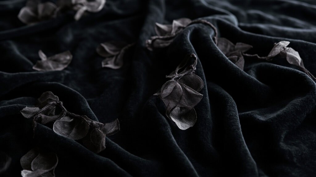 Velours dévoré noir, motifs transparents en rinceaux végétaux.